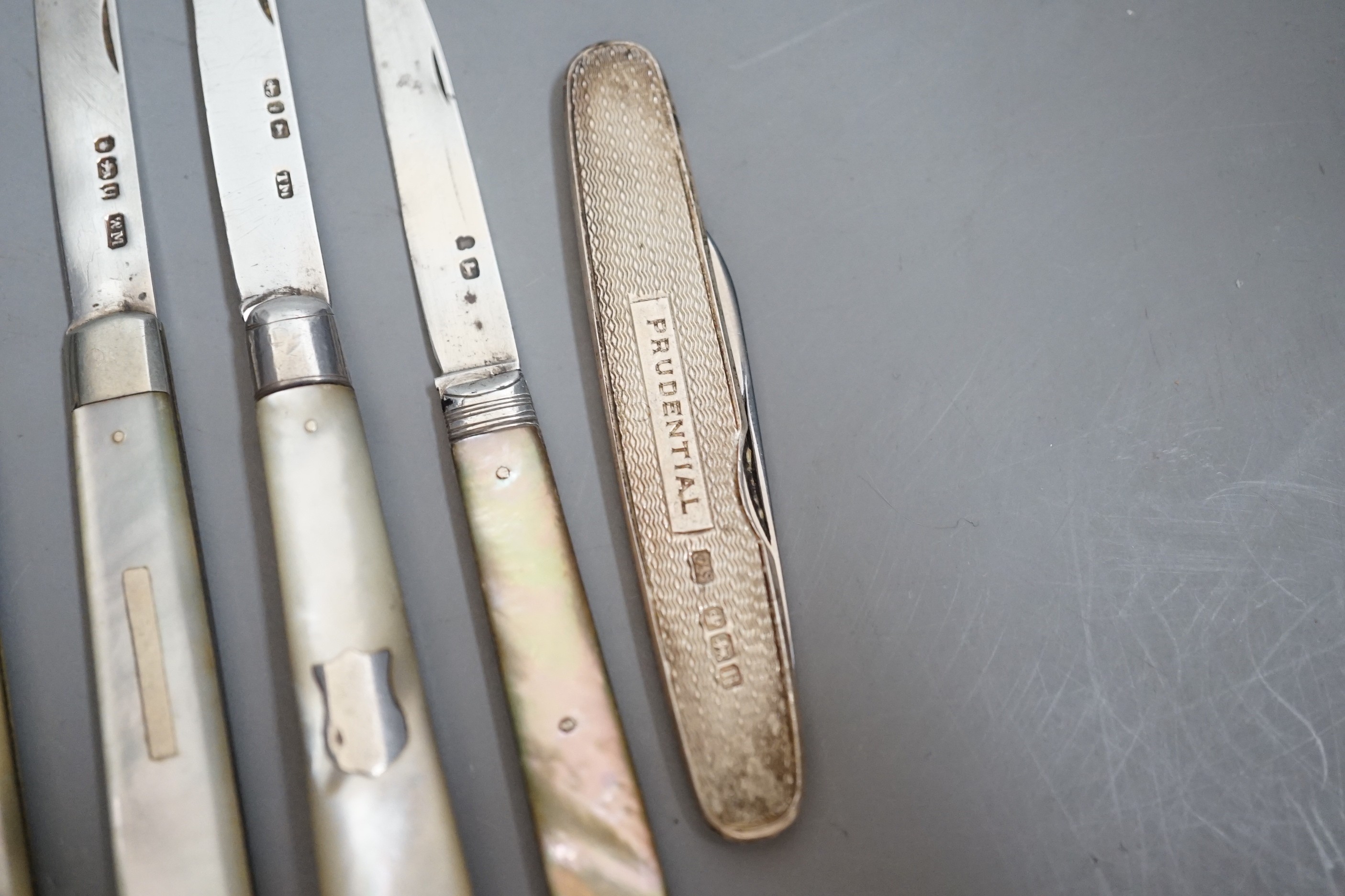 A collection of seven assorted mainly 20th century mother of pearl handled silver fruit knives and a silver cased pen knife.